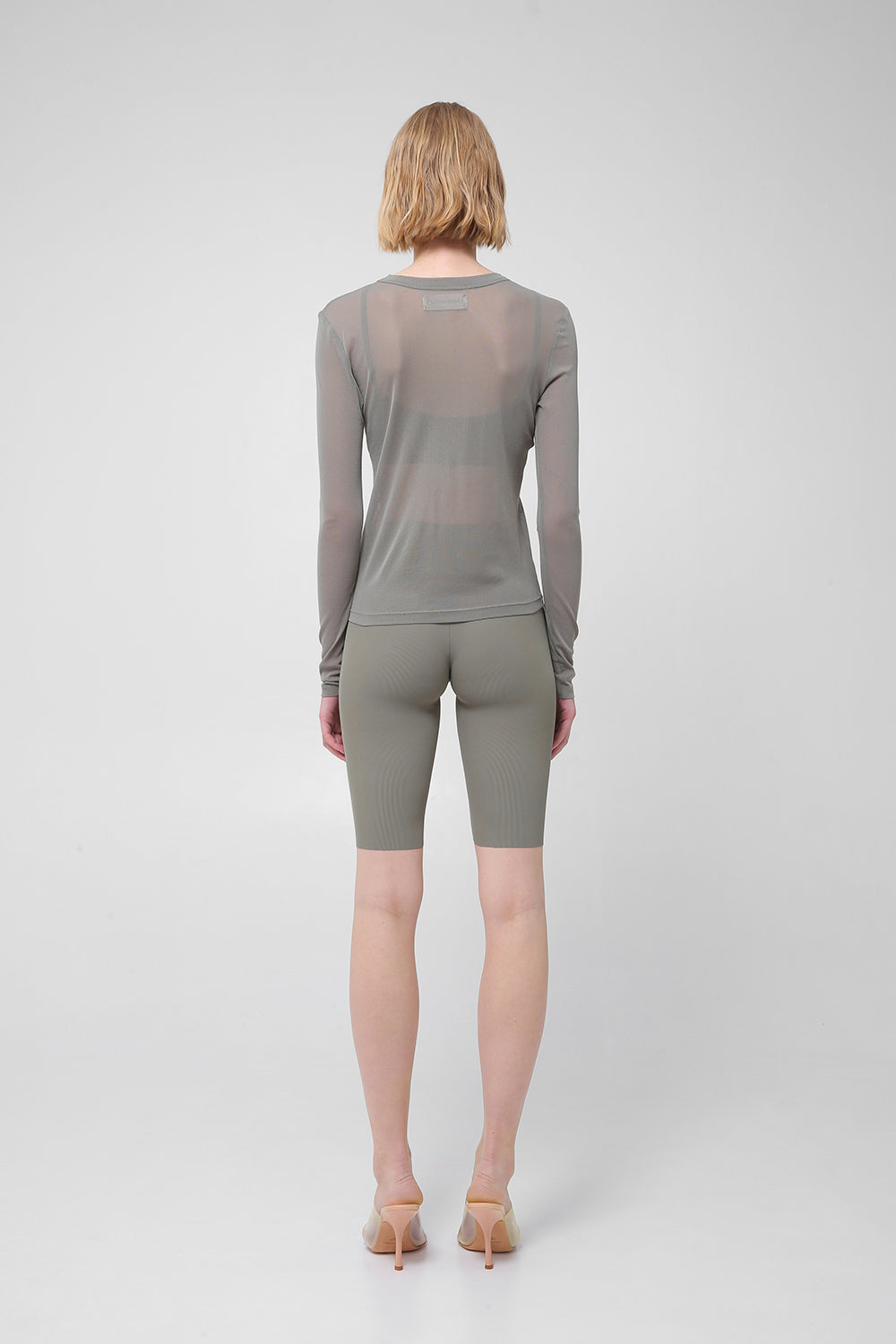 Transparent long-sleeve top with asymmetric hem